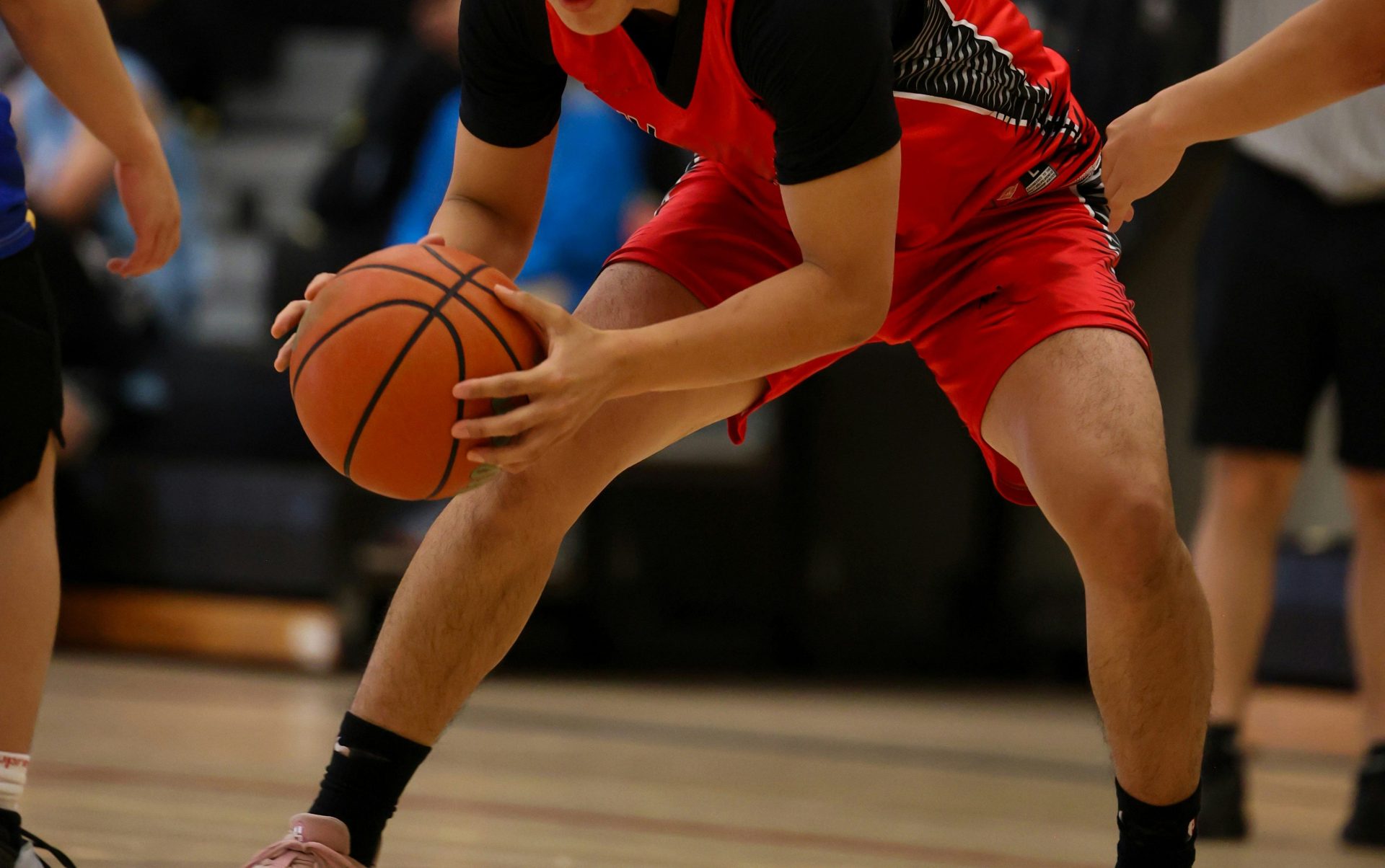 A basketball player is dribbling the ball.